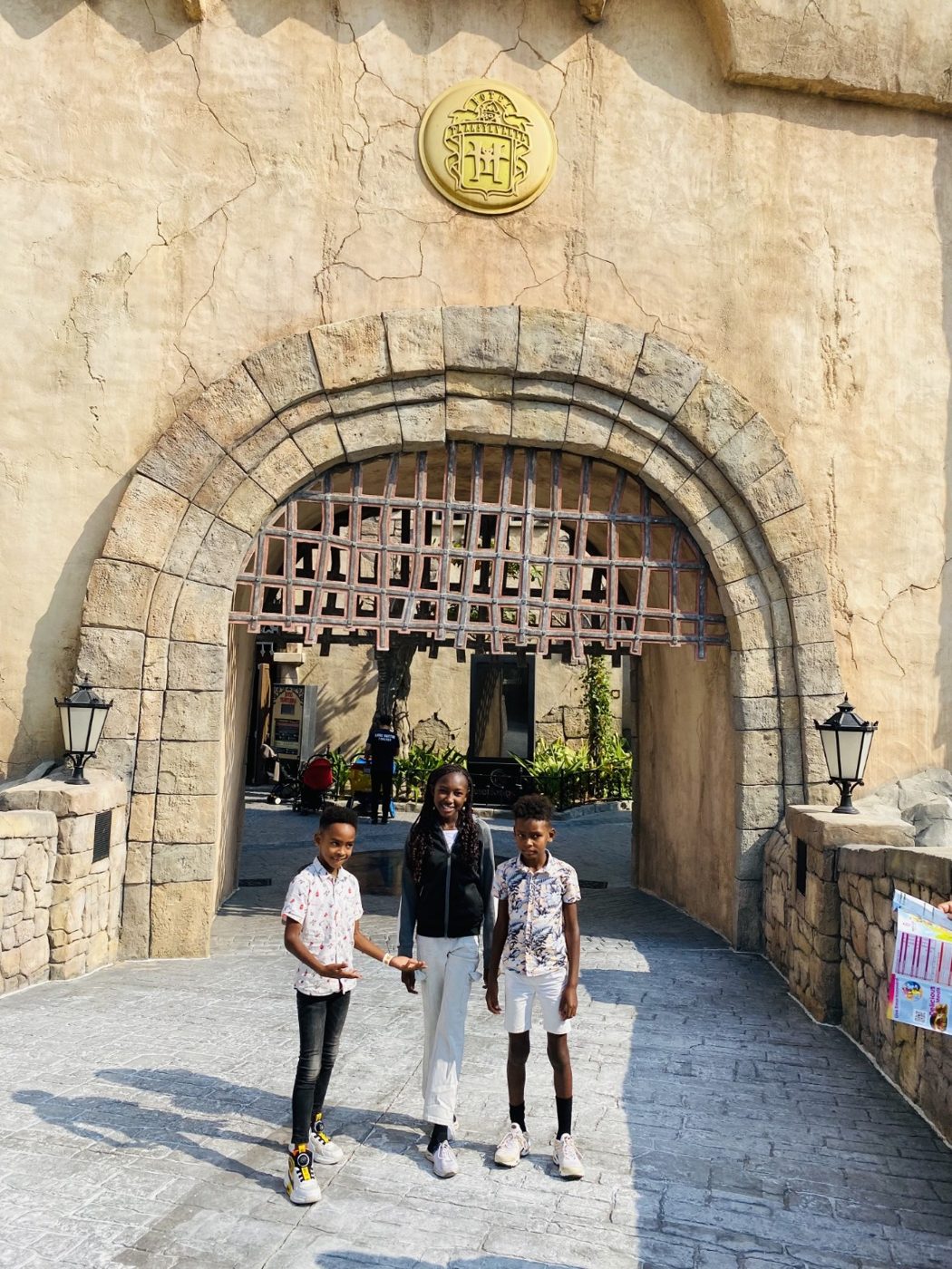 Three children at the Hotel Transylvania entrance.